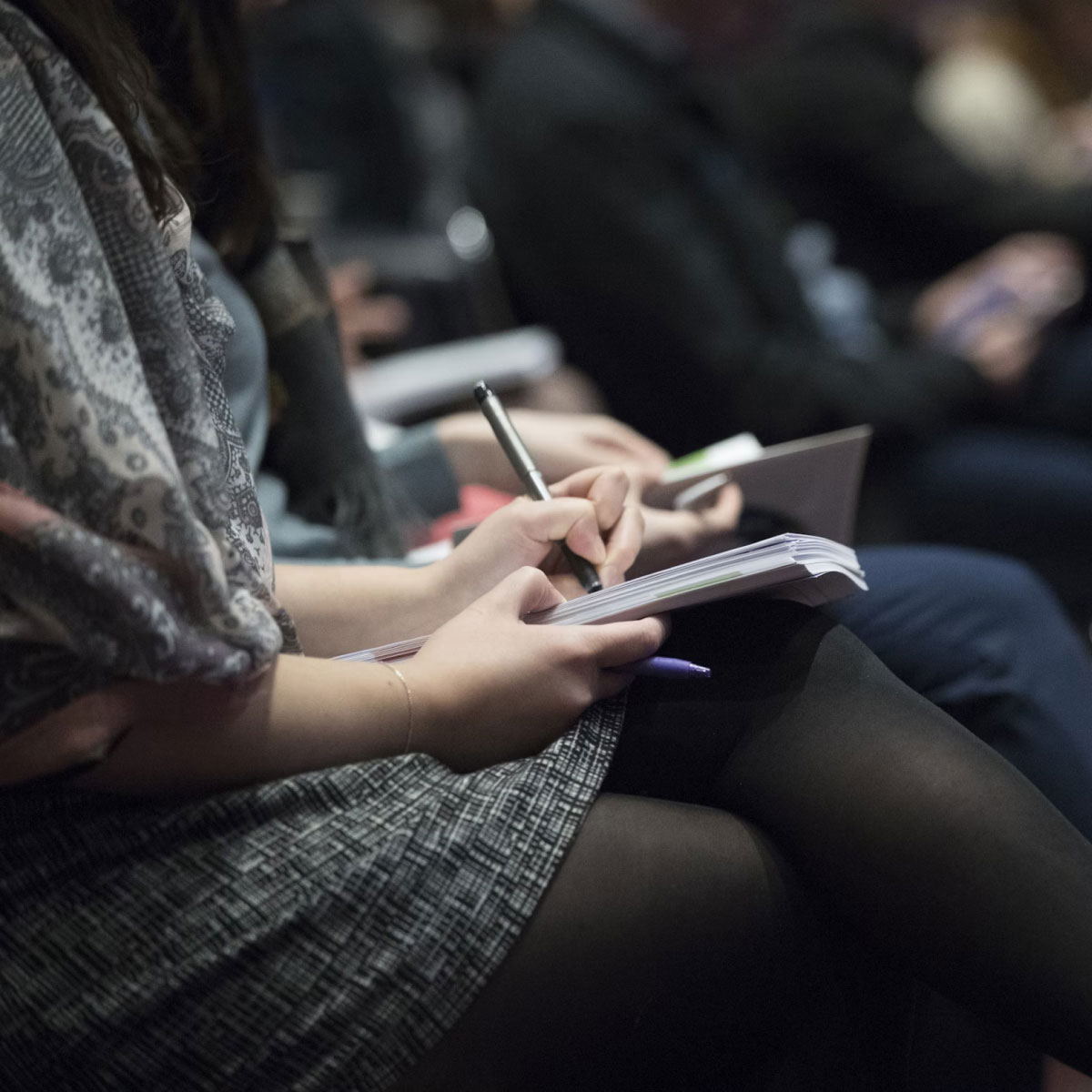 Healthcare professionals sitting and writing notes.